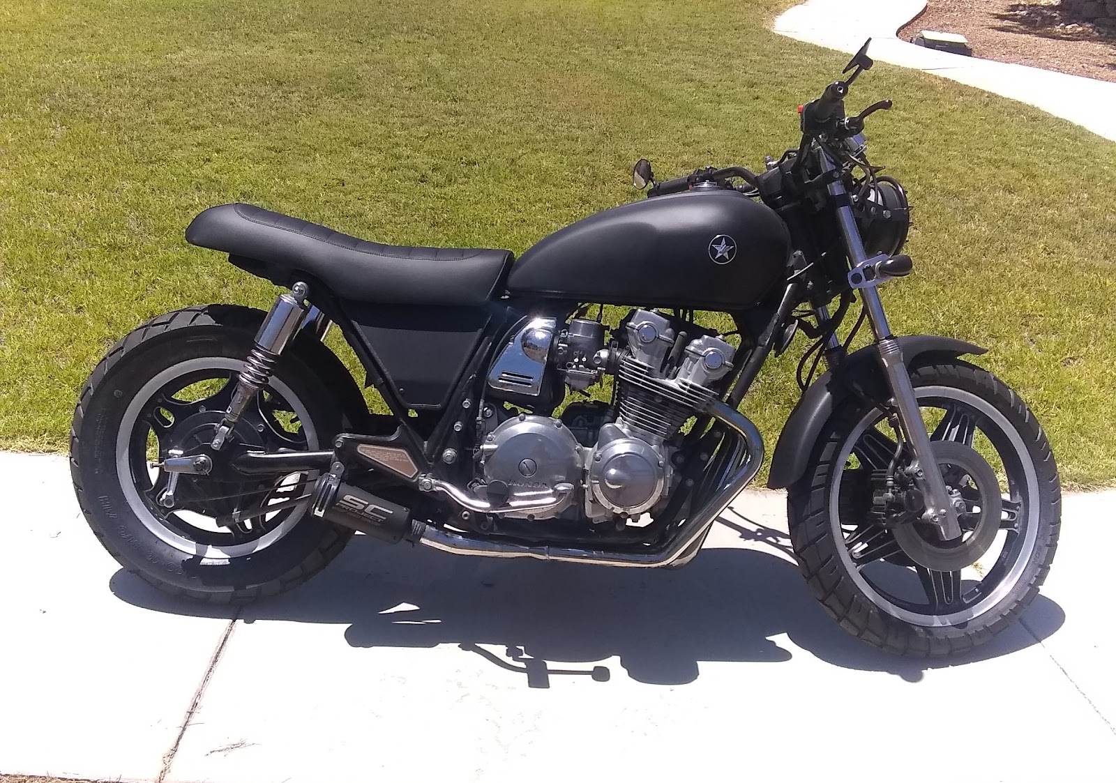 Custom matte-black Honda cafe/brat-style motorcycle build